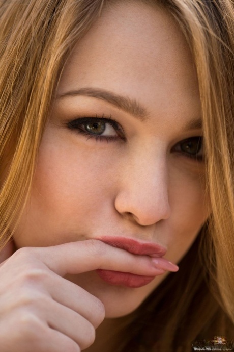 Alluring babe Alaina Fox shows her trimmed pussy up close outdoors